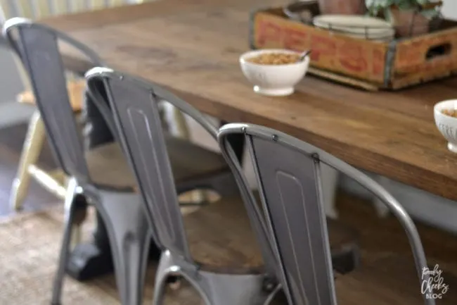 Farmhouse dining room - DIY farmhouse table paired with industrial metal chairs and a bench.