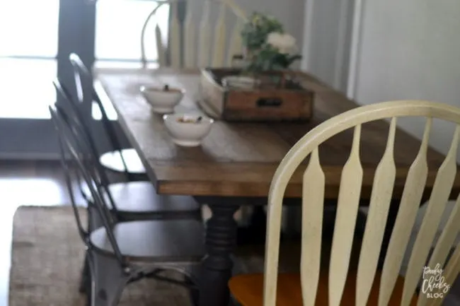 Farmhouse dining room - DIY farmhouse table paired with industrial metal chairs and a bench.