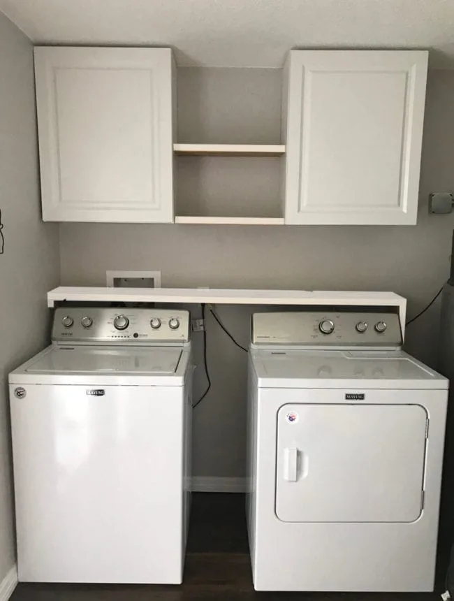 Laundry Room Storage Solutions - Add cabinets and shelving above washer and dryer for storage and organization.