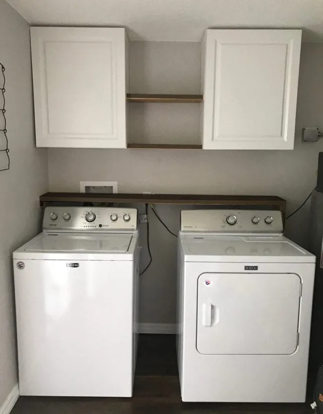 Laundry Room Storage Solutions - Add cabinets and shelving above washer and dryer for storage and organization.