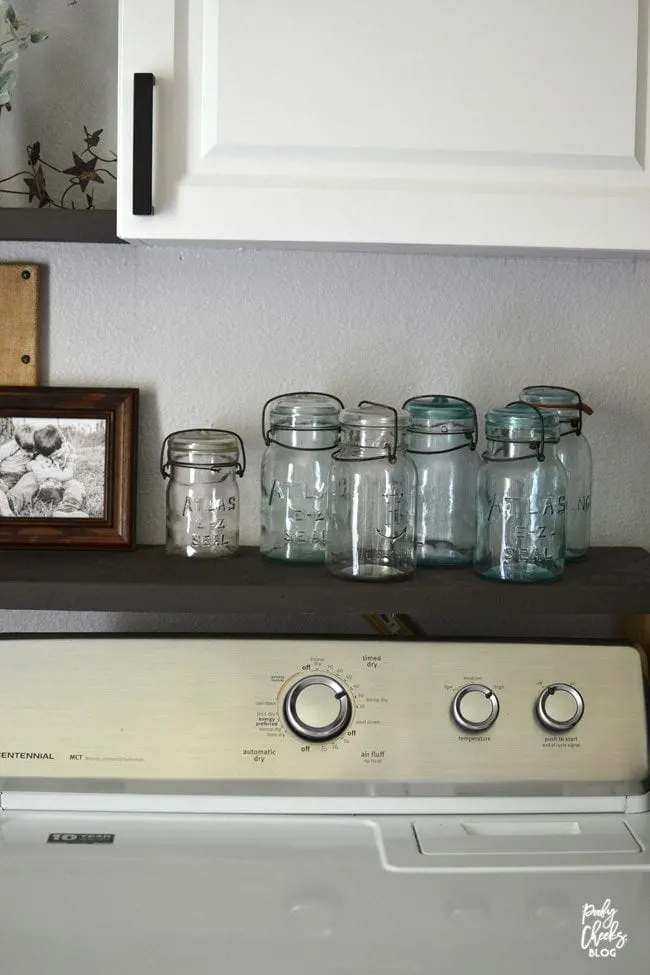 Laundry room before and after - an ugly boring laundry room transformed into a farmhouse laundry room.