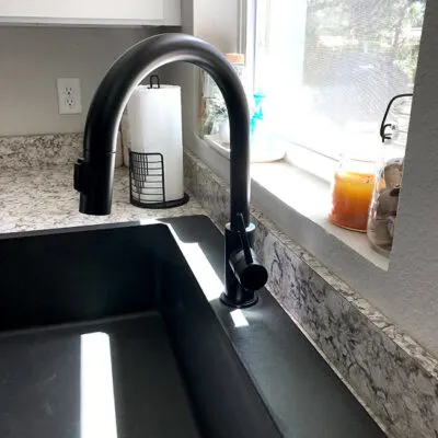 black quartz kitchen sink and black faucet