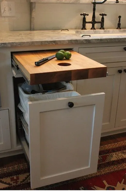 Cutting board over trash can.